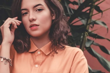 woman wearing a vivid tangerine buttoned shirt