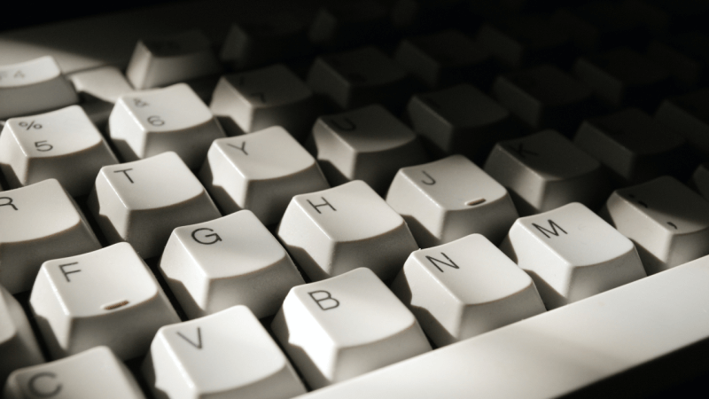 white computer keyboard on black surface