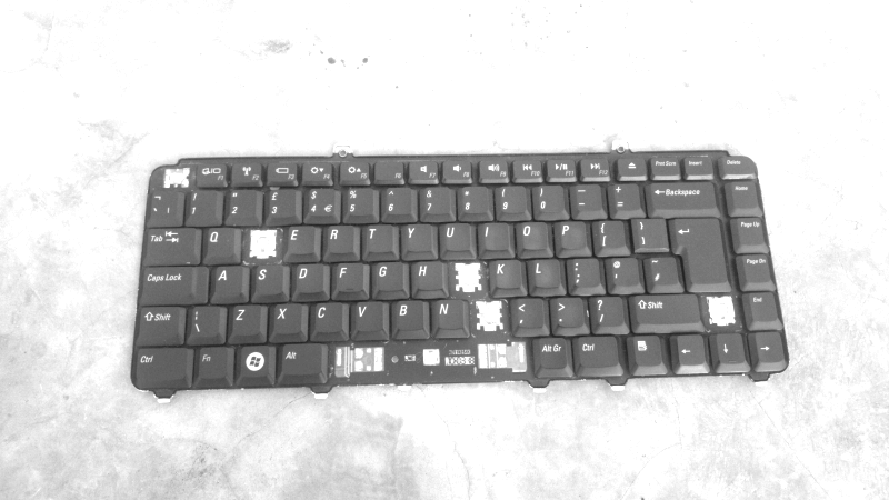 a detached laptop keyboard missing some of its keys